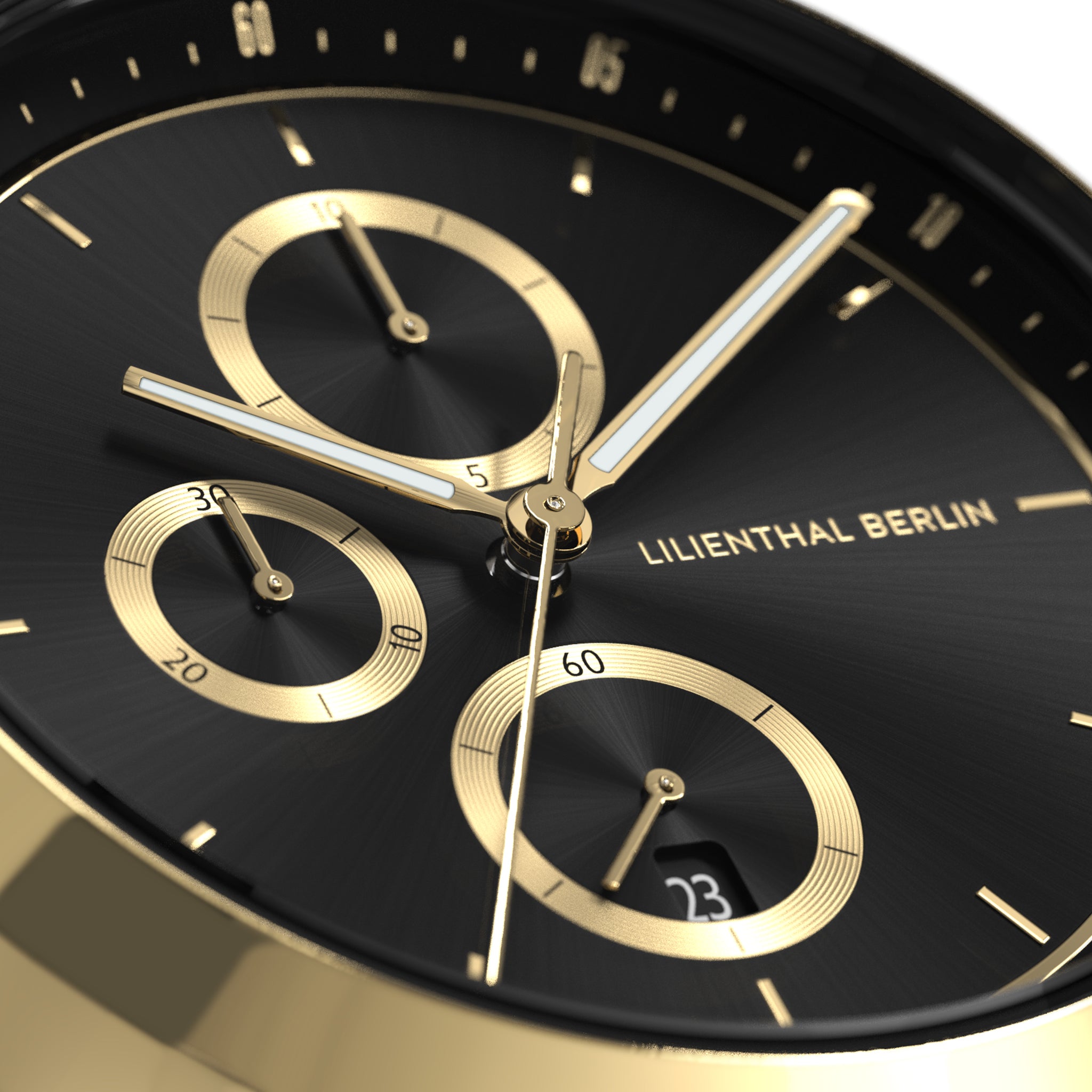Close-up of luxury black and gold chronograph watch face with three subdials and date display