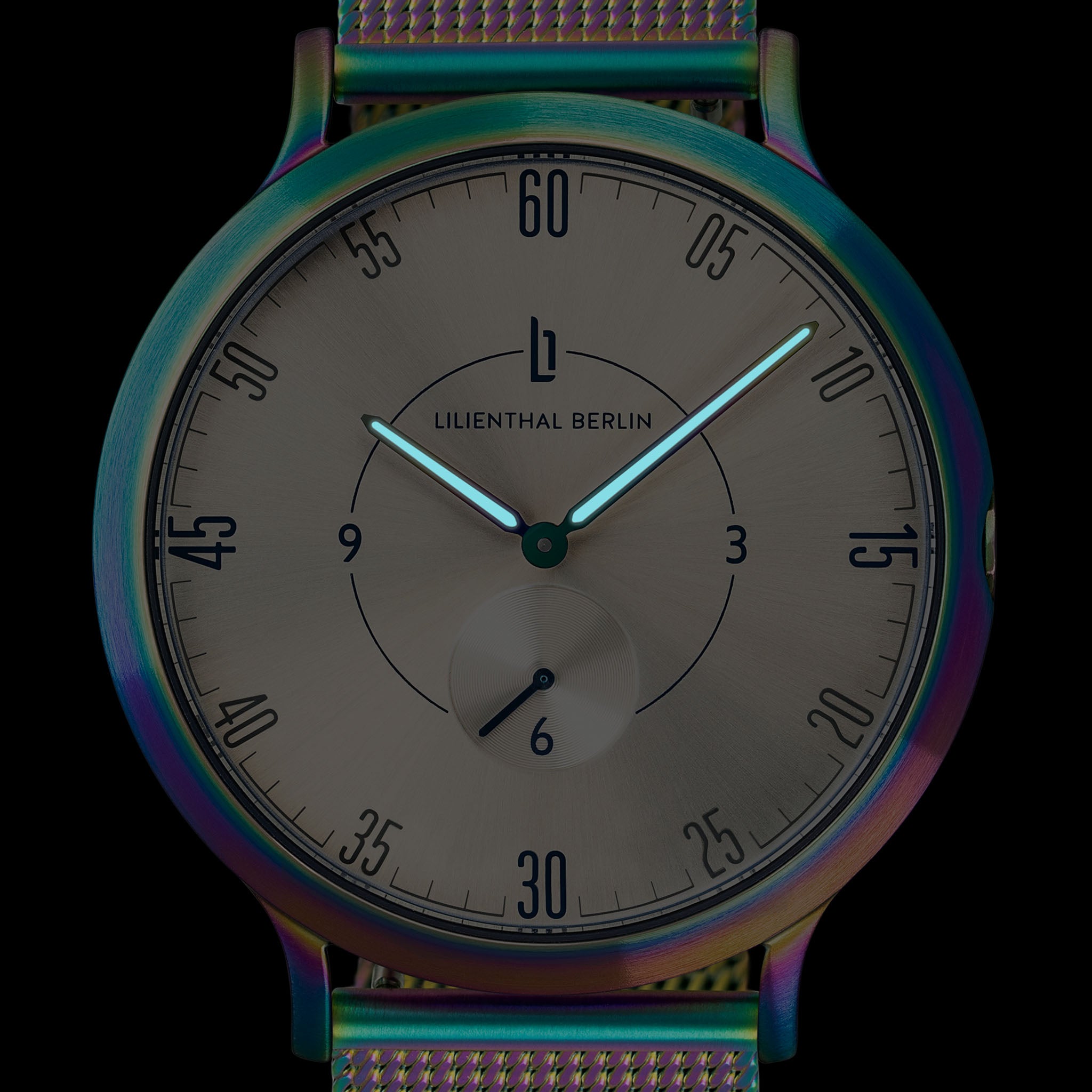 Minimalist analog watch with iridescent case and mesh strap, black dial, luminous hands