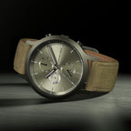 Elegant chronograph watch with olive green dial, date display, and suede leather strap