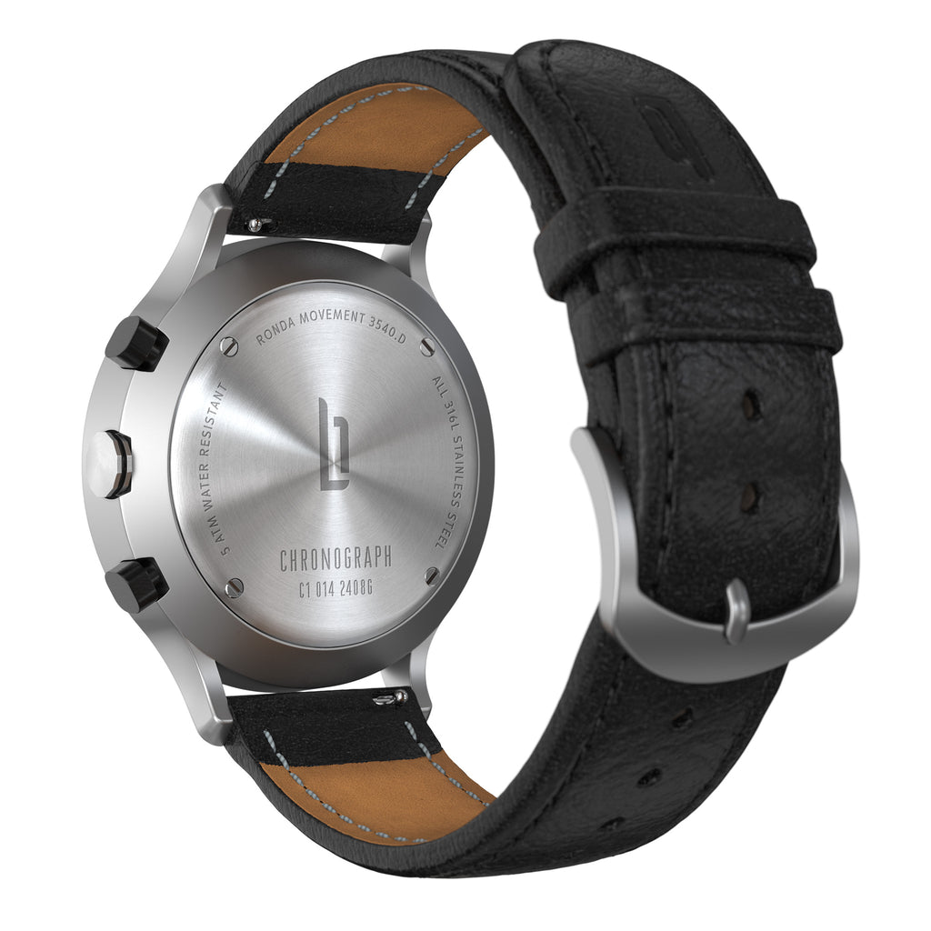 Stainless steel chronograph watch back with black leather strap and engraved details