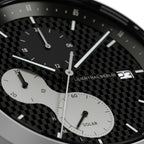 Close-up of a solar-powered chronograph watch face with subdials and date display
