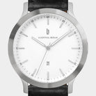 Minimalist silver watch with white dial, date display, and black leather strap