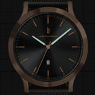 Minimalist black watch with bronze case, date display, and luminous hands