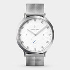Minimalist silver mesh watch with white dial and black numerals on a light background