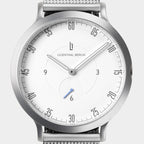 Minimalist silver wristwatch with white dial, mesh strap, and modern hour markers.
