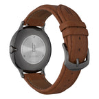 Stainless steel watch back with engraved details and brown leather strap